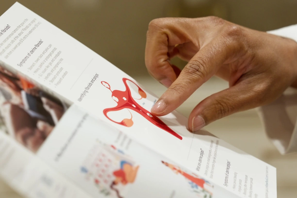 Provider pointing to a pelvic anatomy diagram during a gynecology consultation at Renova Total Health