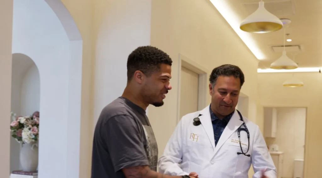 Physician welcoming a patient in the hallway at Renova Total Health in Carmel, Indiana