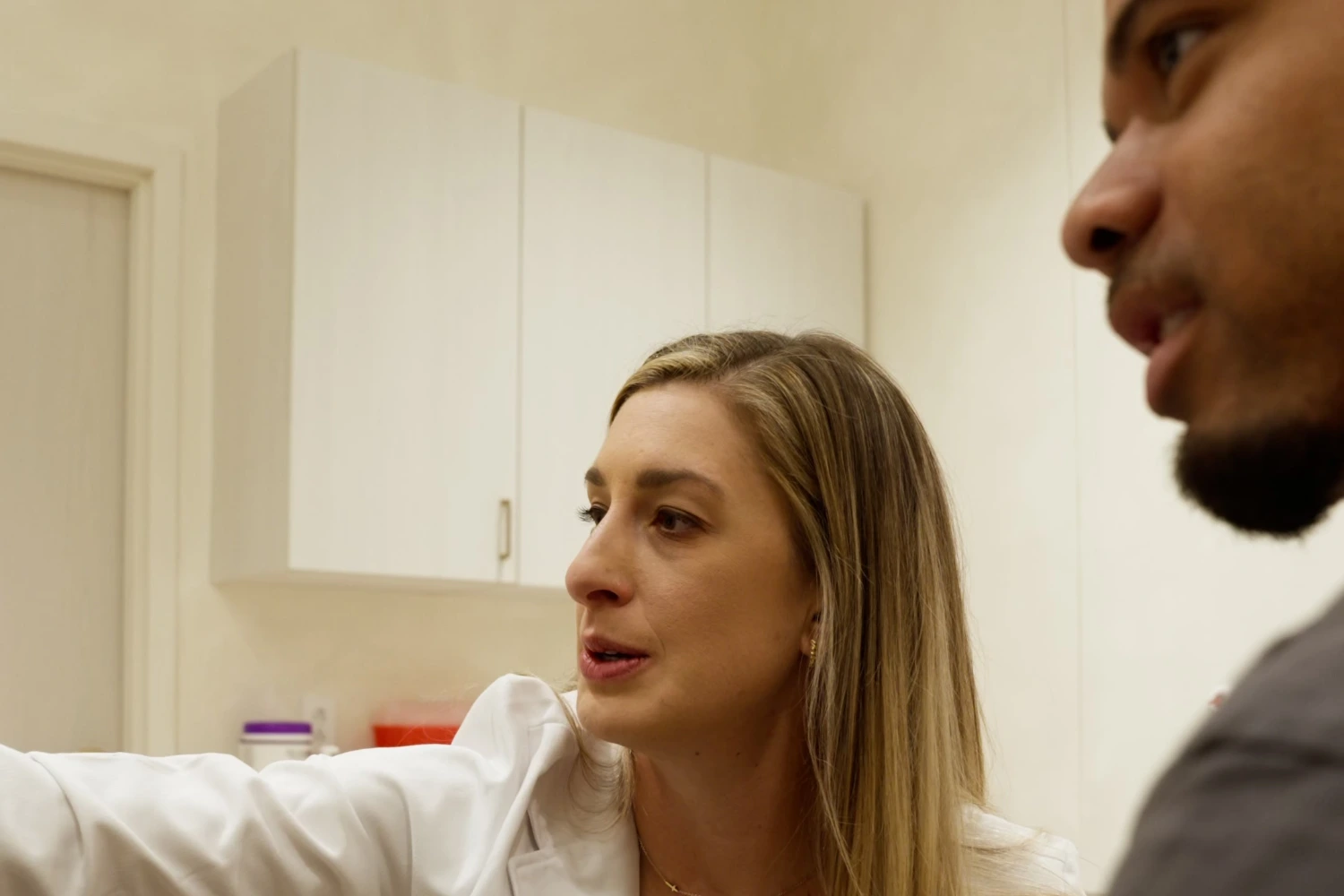 Renova Total Health provider explaining a peptide therapy plan to a patient during a consultation