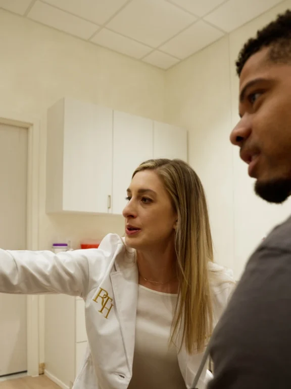 Provider explaining next steps to a patient in an exam room at Renova Total Health