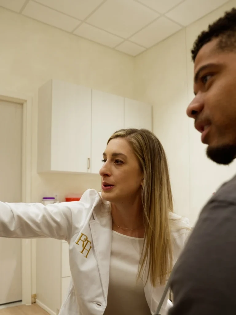 Provider explaining next steps to a patient in an exam room at Renova Total Health
